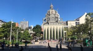 Tourists visiting Plaza Botero in Medellín surrounded by Fernando Botero sculptures